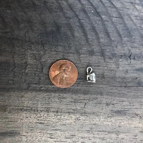 The recovered diamond pendant held up
