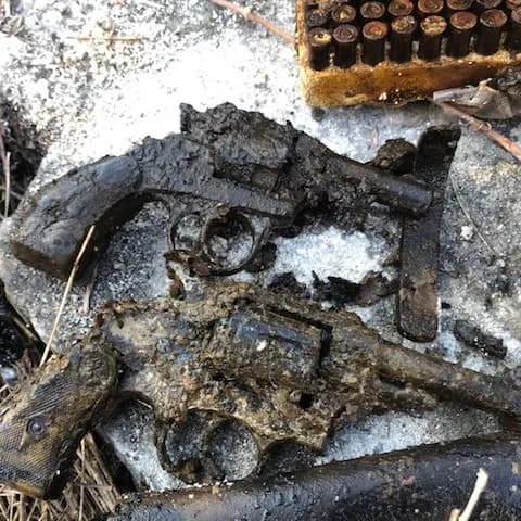 Two handguns and holsters from the cache